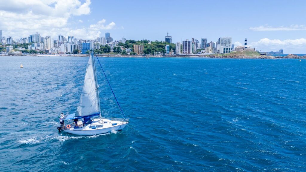 Sailboat sailing near the Salvador, Brazil skyline on a sunny summer day.